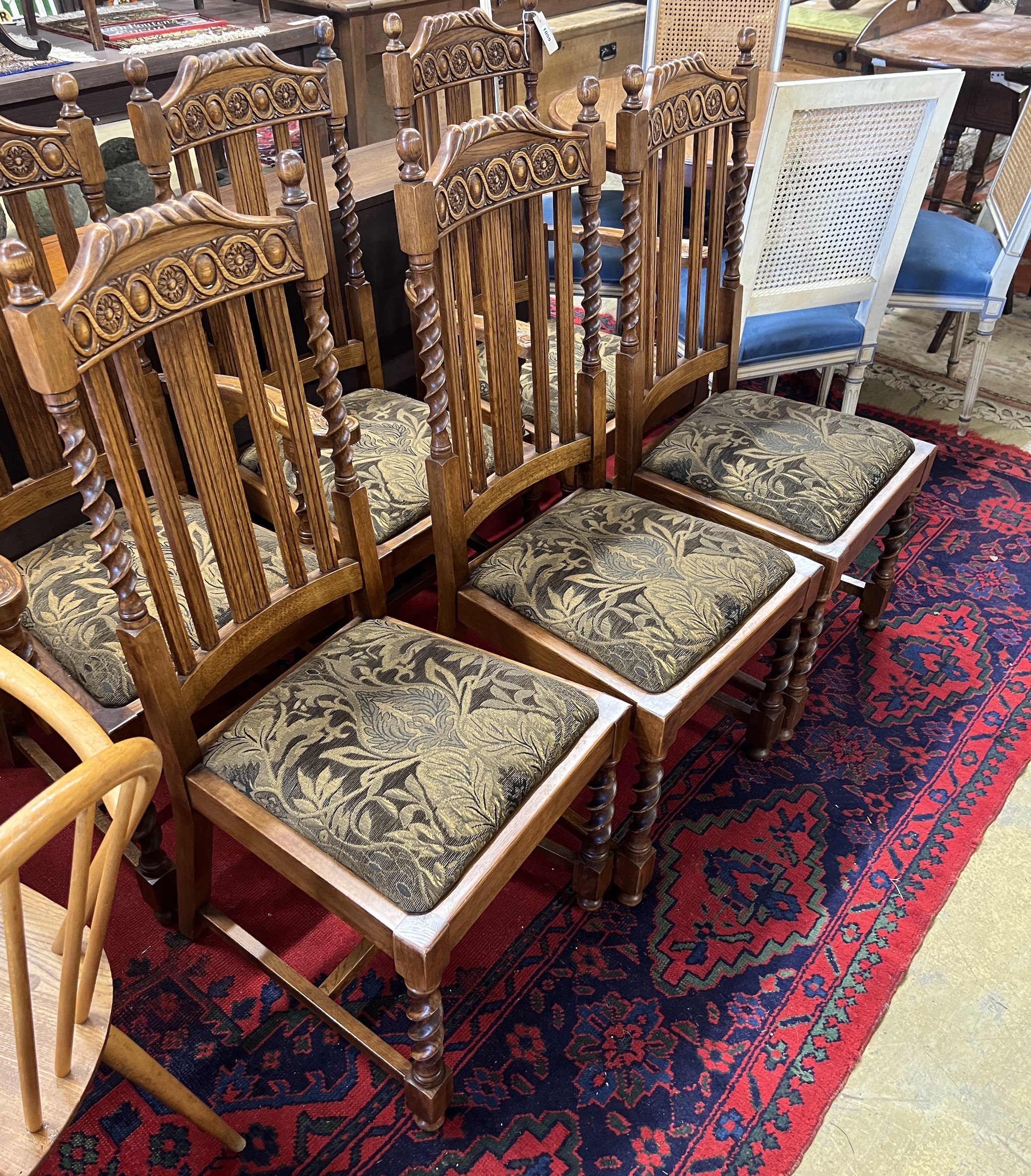 A set of six 1920's oak barley twist dining chairs, two with arms